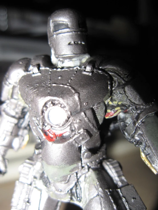 a silver toy figure in metallic with lots of features