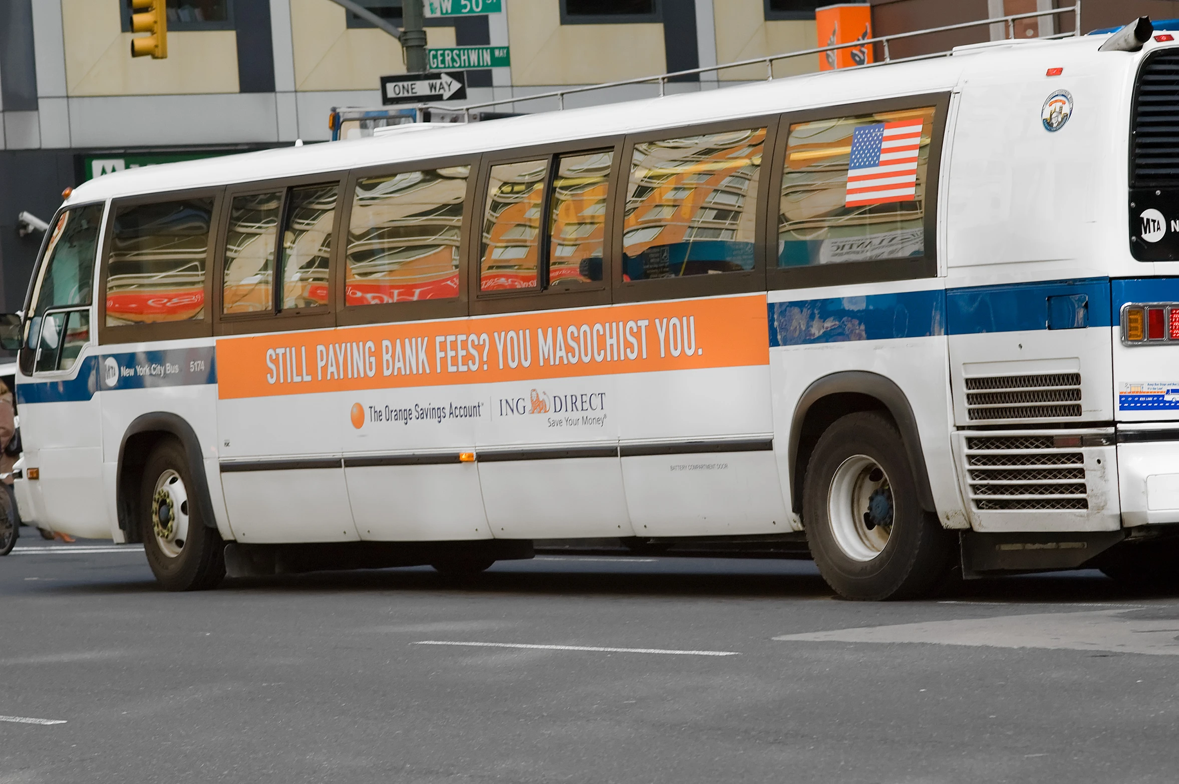 the city bus is waiting for a traffic light