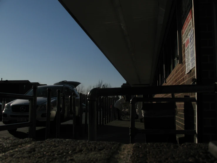 a white truck parked next to a brown building