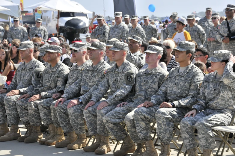 large military event with a large group of people sitting in the rows