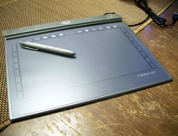 a pen laying on top of a tablet computer