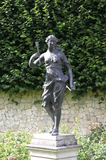 a stone statue of a woman holding a flag with both hands