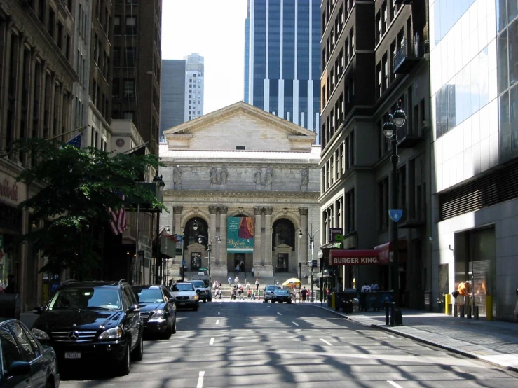 the buildings are lined with cars on the road