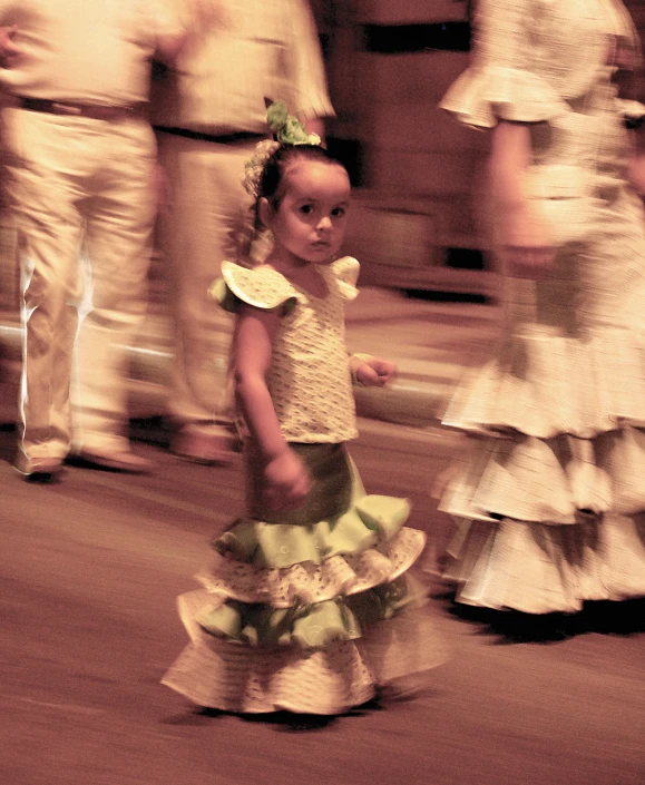 the little girl is walking by herself in dresses