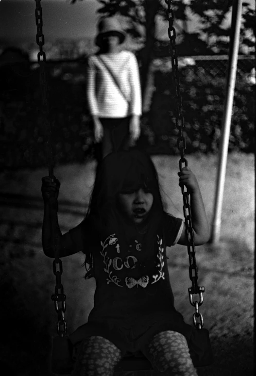 a  on a swing at a playground