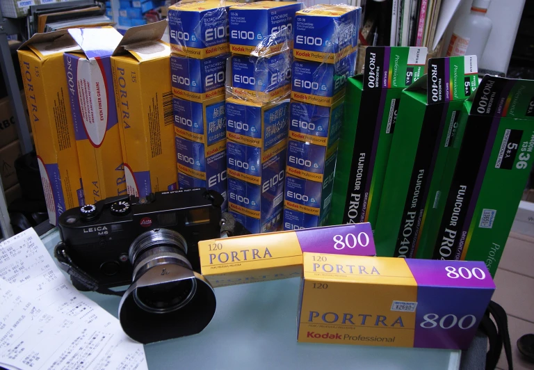 a table topped with books and two different types of cameras