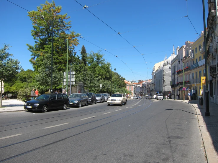 the street in a small city is lined with cars