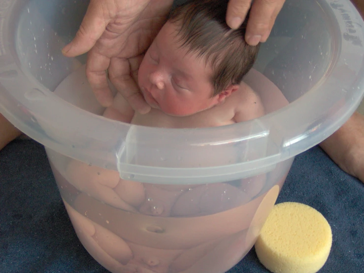 a baby is being bathed in an inflatable tub