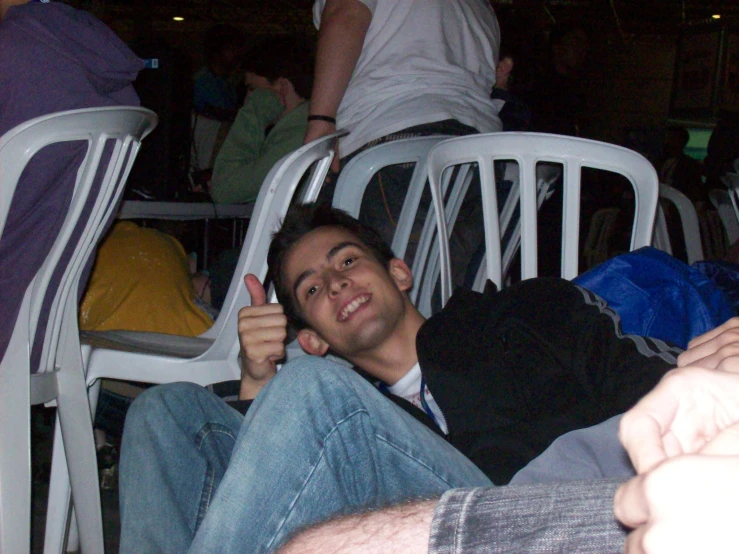 man laying on a chair while smiling for the camera
