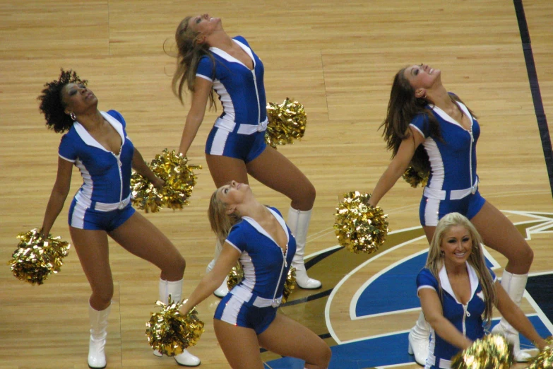 a group of cheerleaders perform on the court for a group po