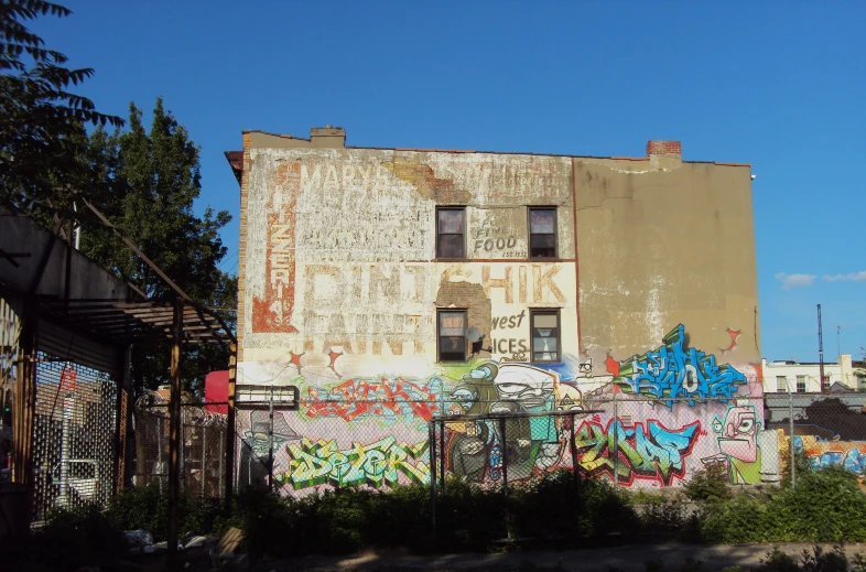 graffiti is spray painted on a building on the corner