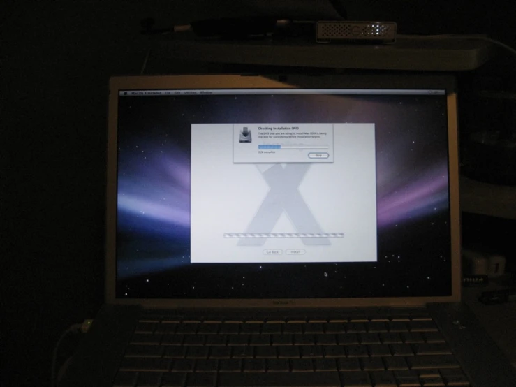 an open mac computer monitor in the dark
