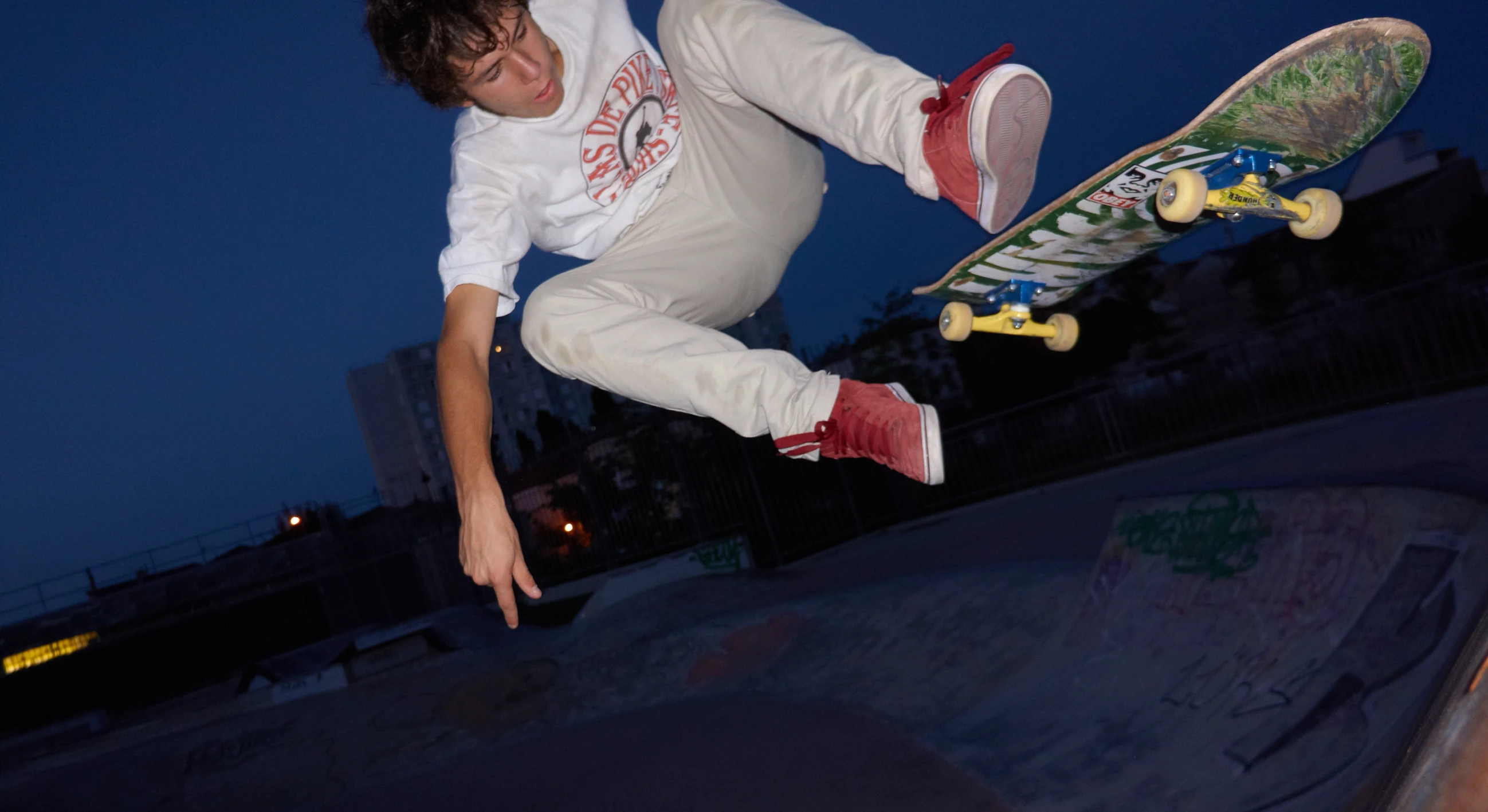 the skateboarder is practicing his tricks at night