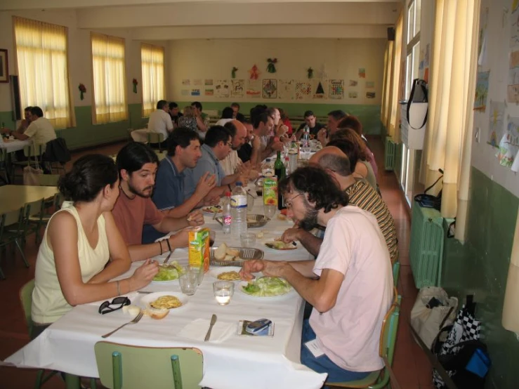 several people are eating at an indoor restaurant