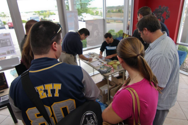 people are gathered together in a restaurant for a meal