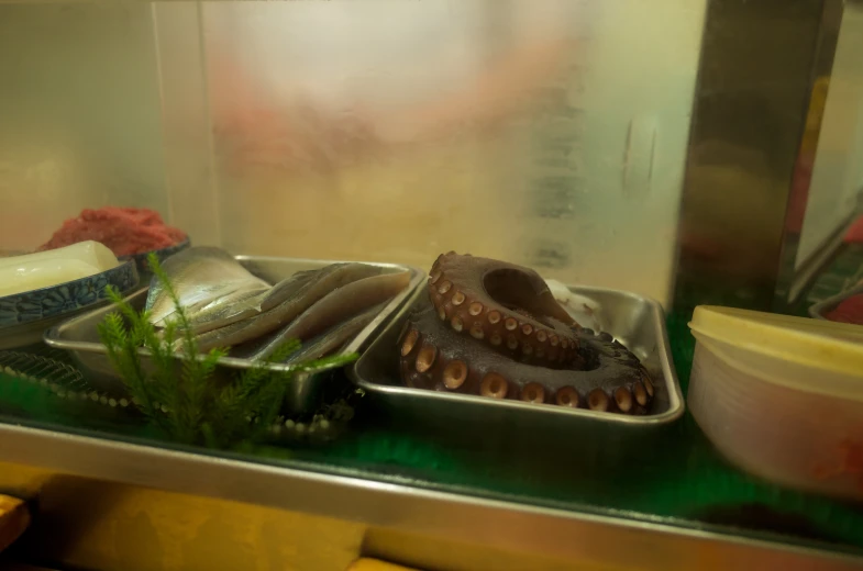 three trays of food in a metallic container