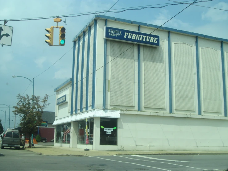 an intersection with traffic lights and an old theatre