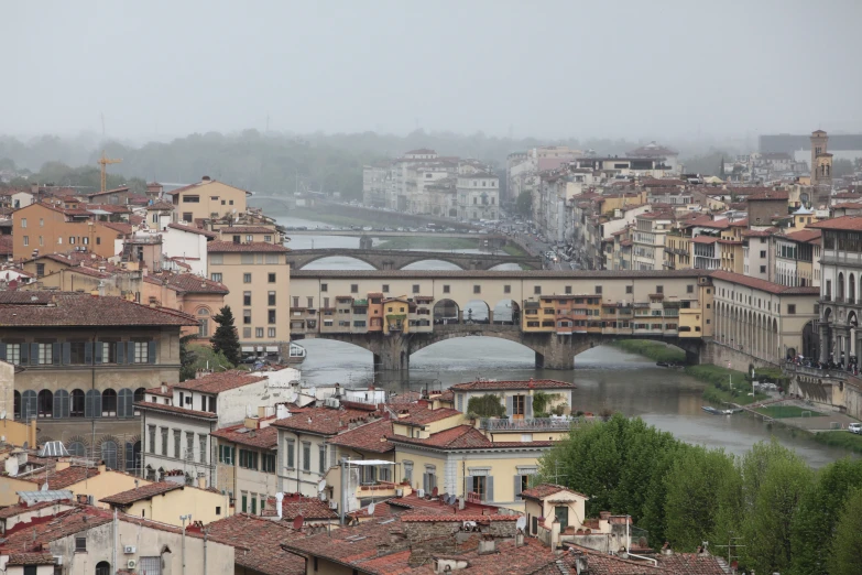 many buildings and bridges are seen from atop