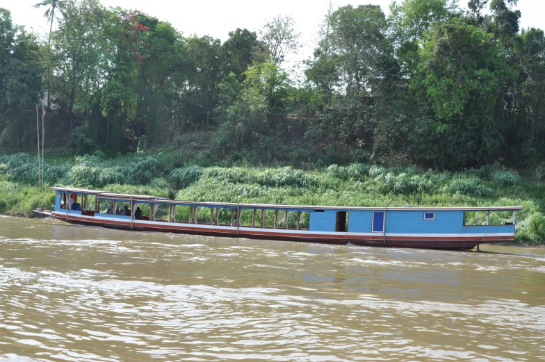 there is a long boat with several people sitting on it