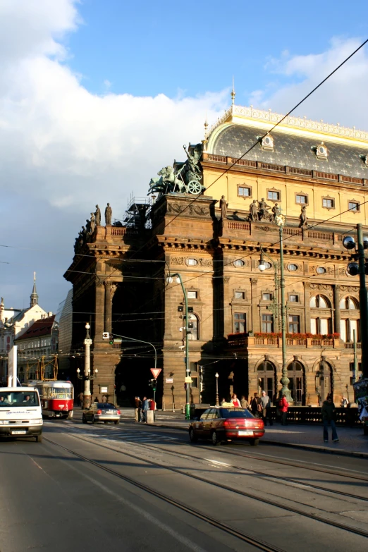 a large building with cars and people on it