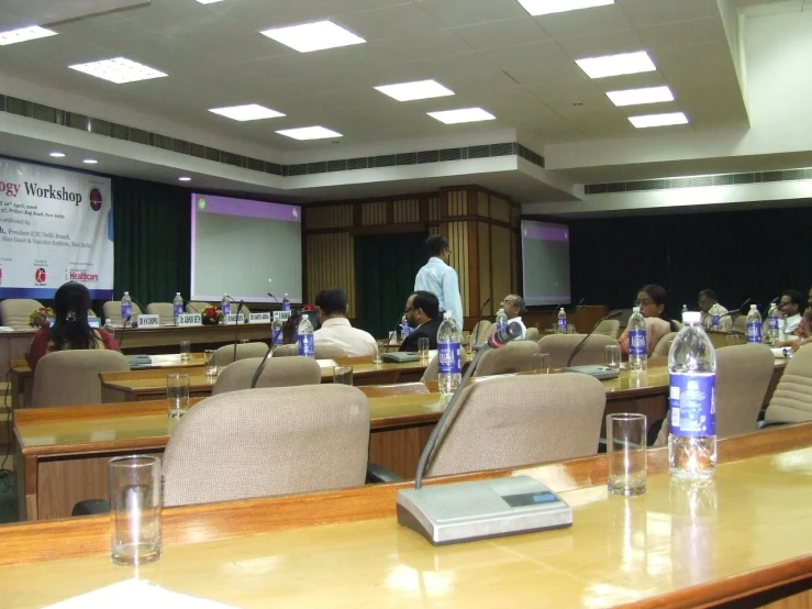 many people in a room with large desks