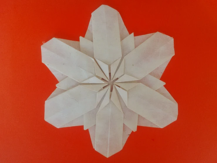 origami snowflake on an orange background