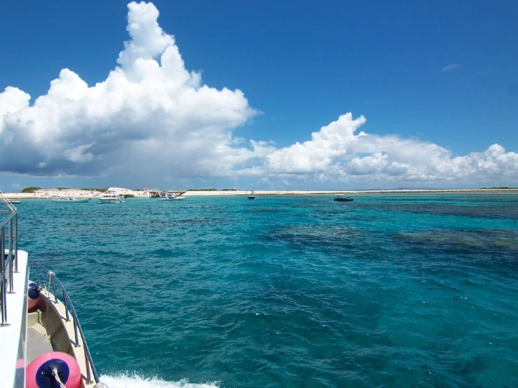 view from a boat looking into water to small islands in the distance