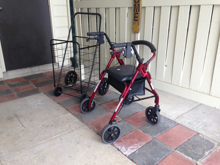 a trolley with a chair attached and a cart next to it