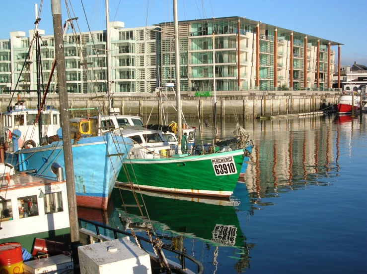 boats docked on water near large buildings and other buildings