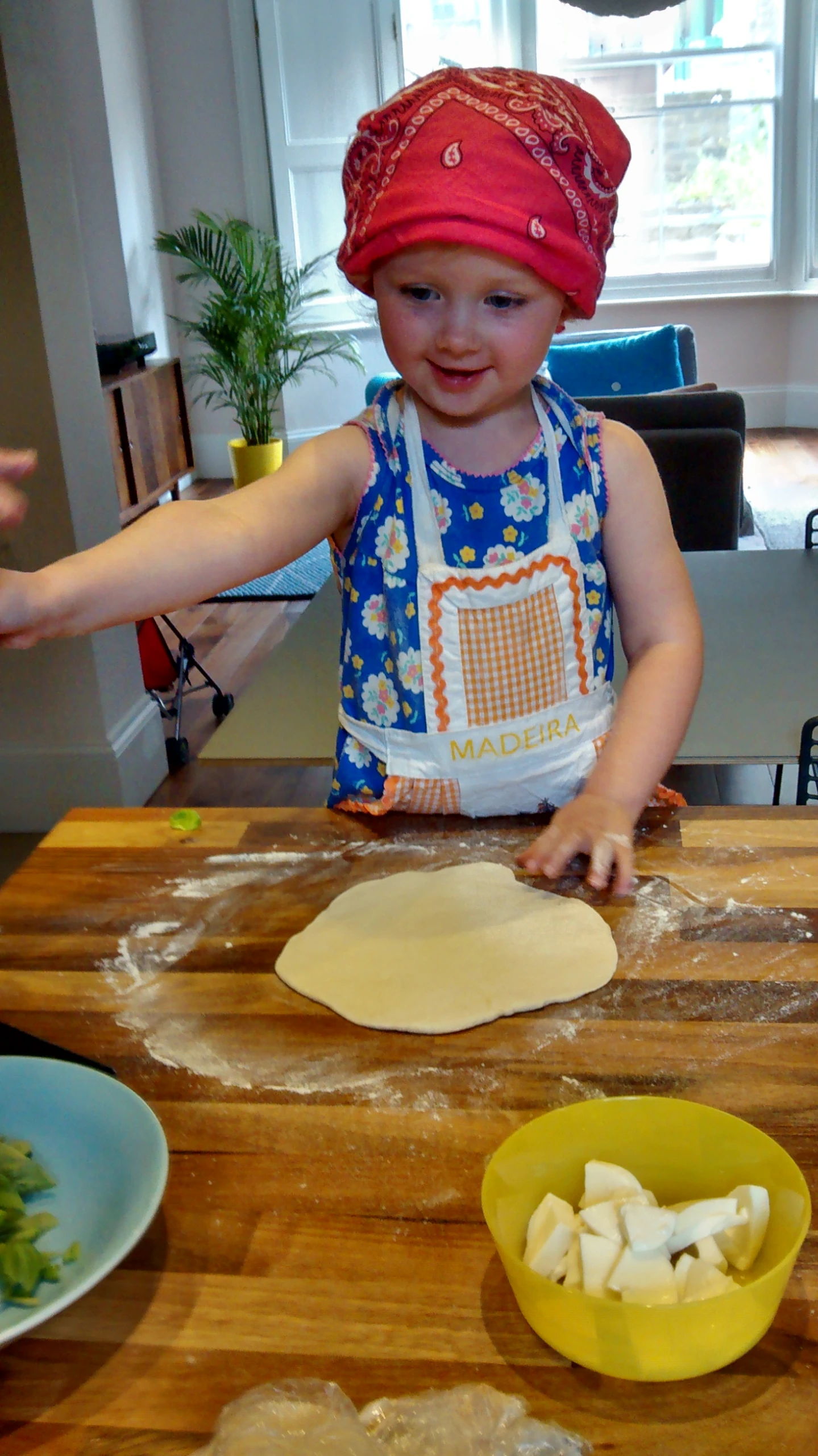 a child who is making bread on a counter