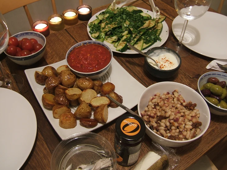 a dining room table is filled with different types of food