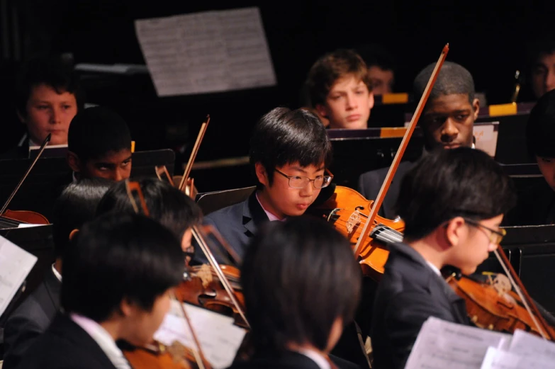 the young orchestra has lots of music students behind them