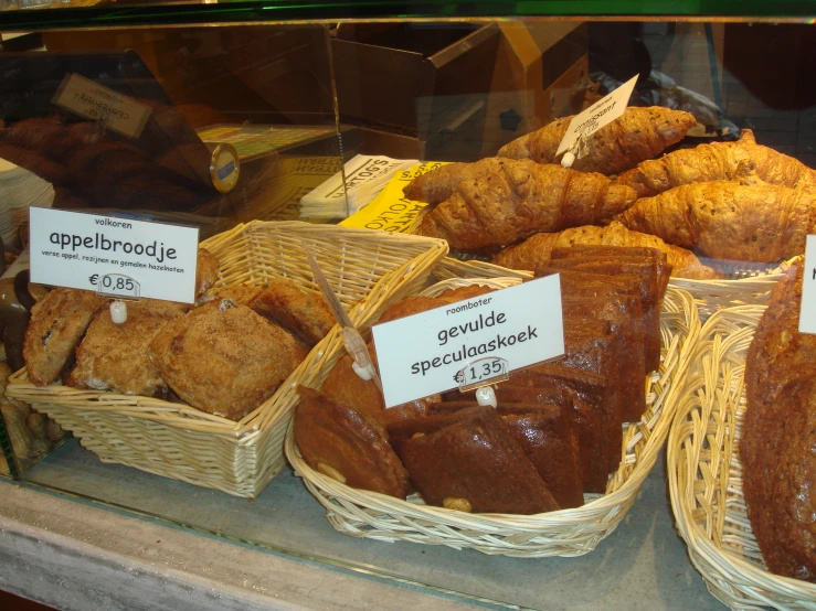 baskets of pastries in a display case in a bakery