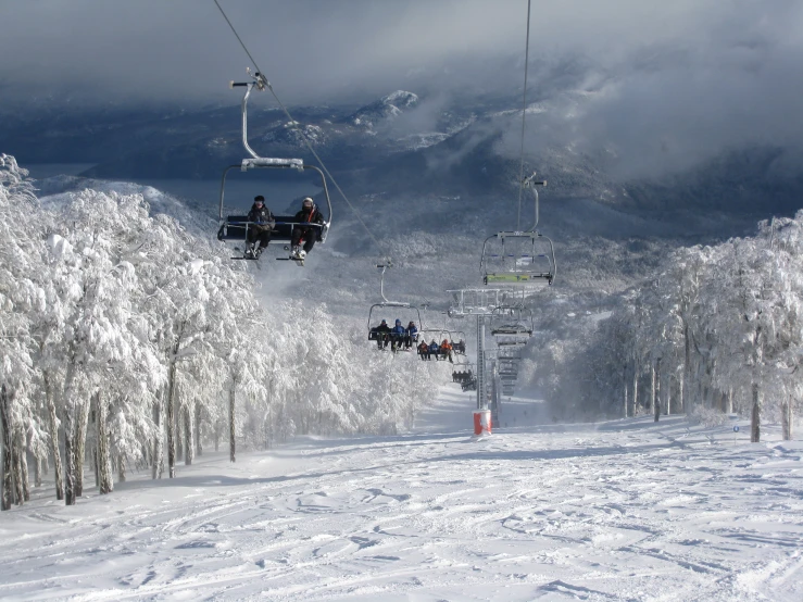 the ski lift lifts people up the snow covered slope