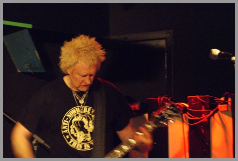 a person playing guitar on a stage