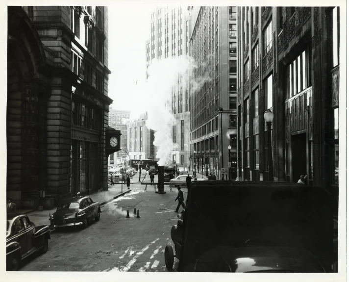 a man is walking through a street with buildings and cars