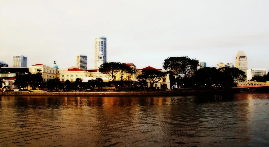 the city on a rainy day is reflected in the water