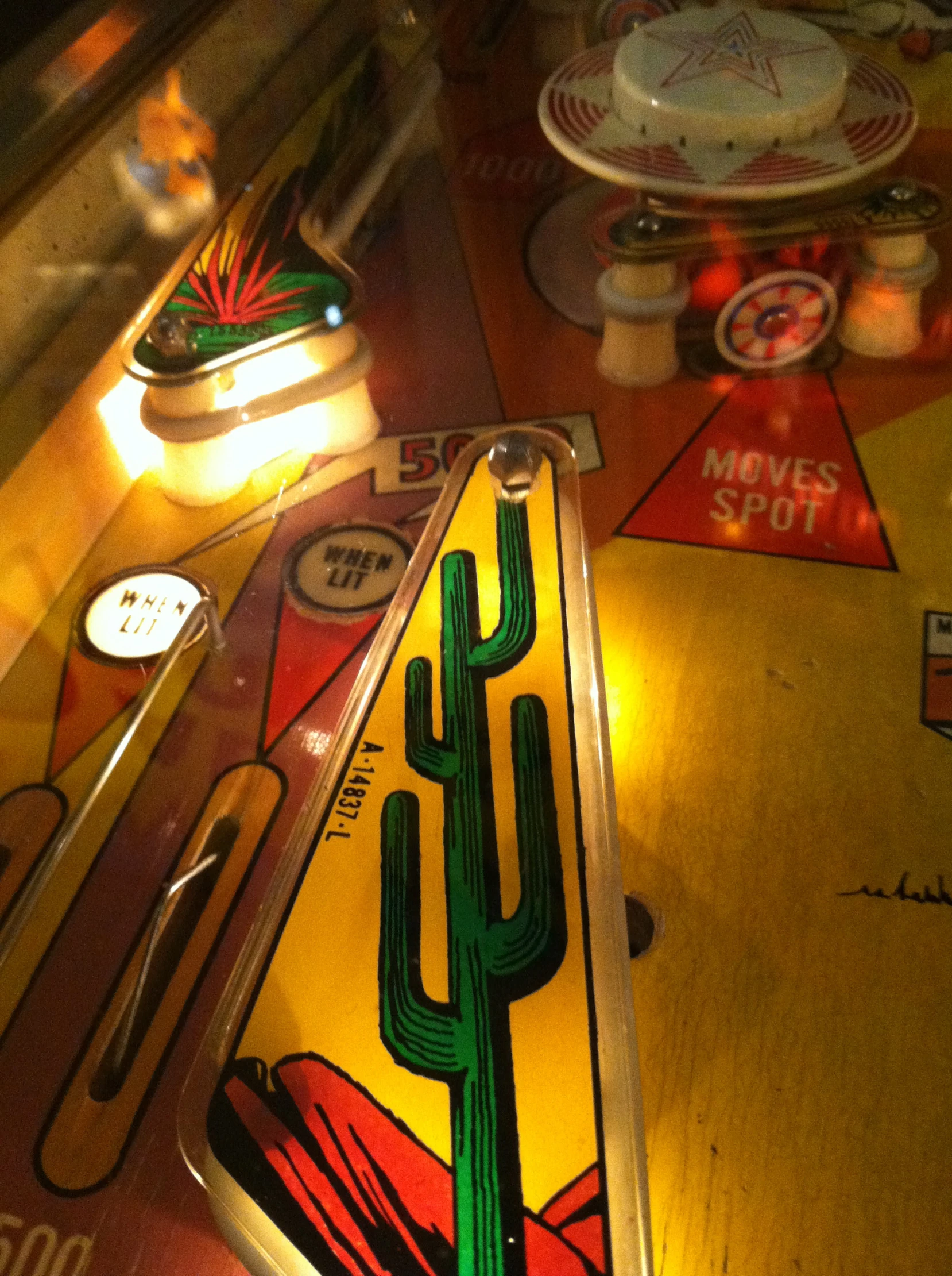 an old pinball machine with a cactus decal