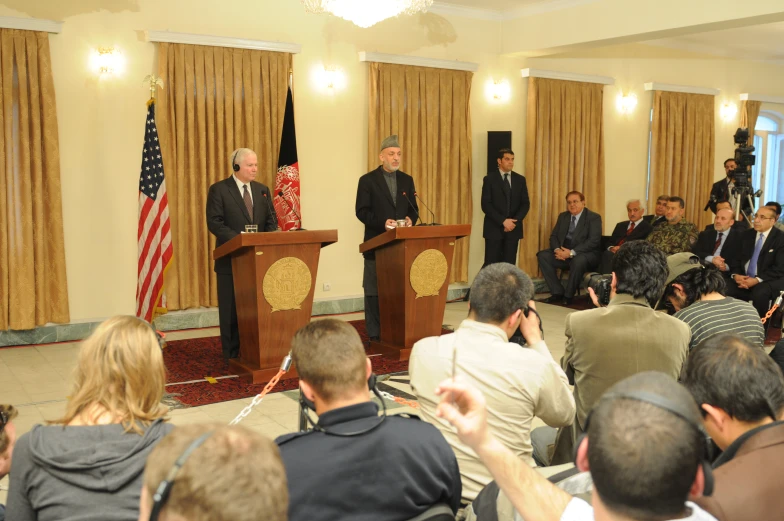 a group of men standing in front of microphones