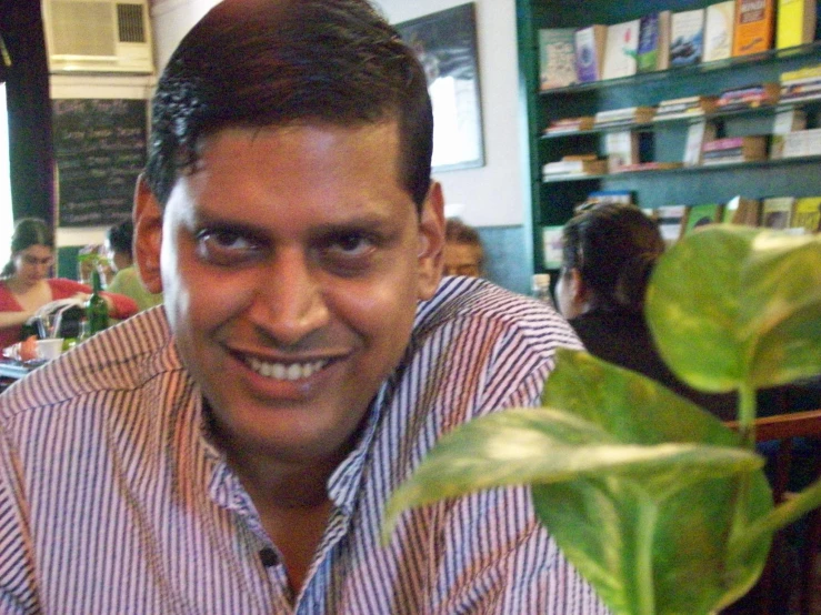 a man sitting down with some plant growing out of his lap