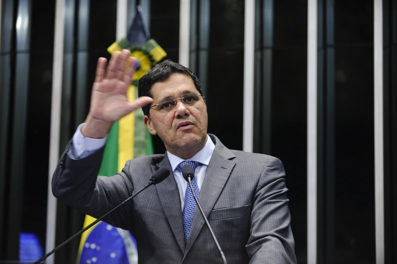 a man in a suit and tie giving a speech