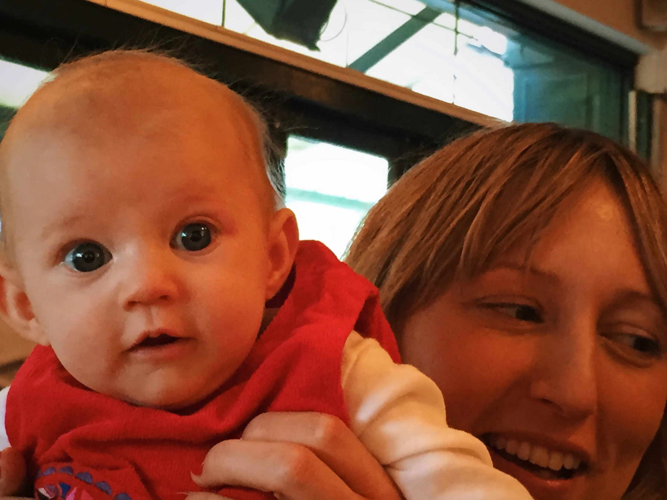 a woman with a baby wearing a bandana