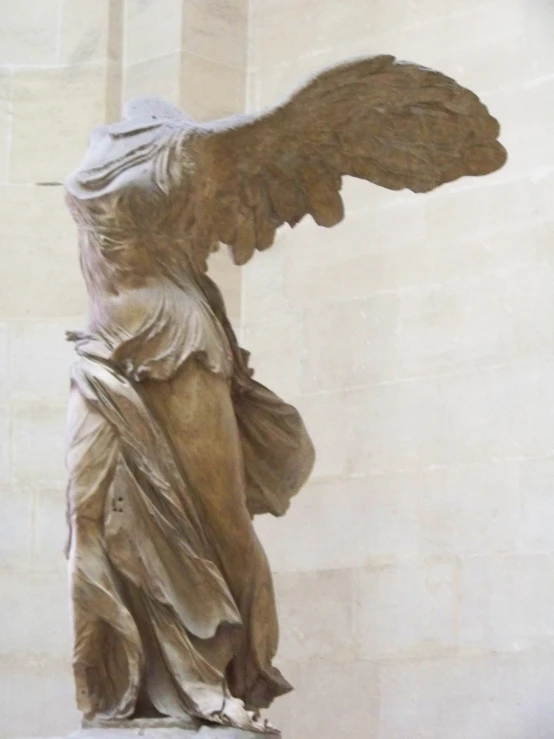a large statue of an angel with its hands together