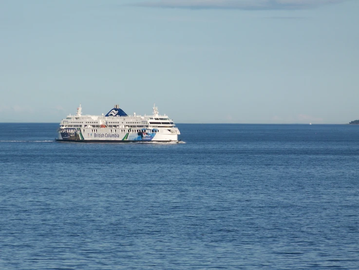 a cruise ship is in the middle of a calm blue sea