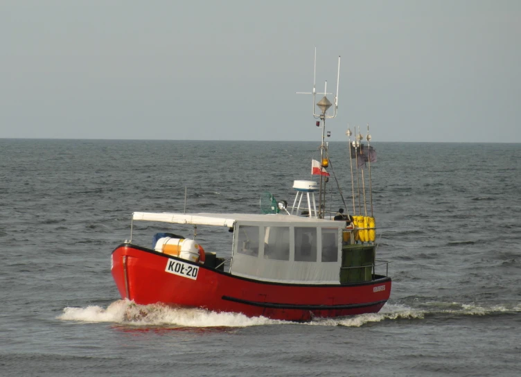 a fishing boat on choppy waters near the shore