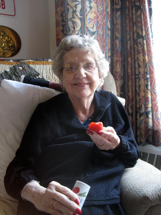 a woman is sitting on a couch eating soing