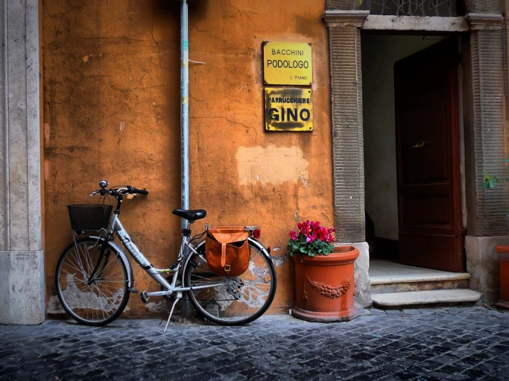 a bike parked on the side of an orange building