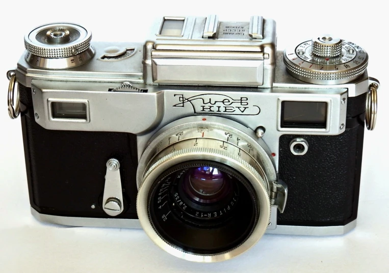 an old film camera on a white table