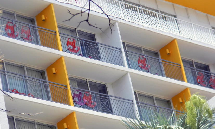 an apartment building with a large yellow balconi