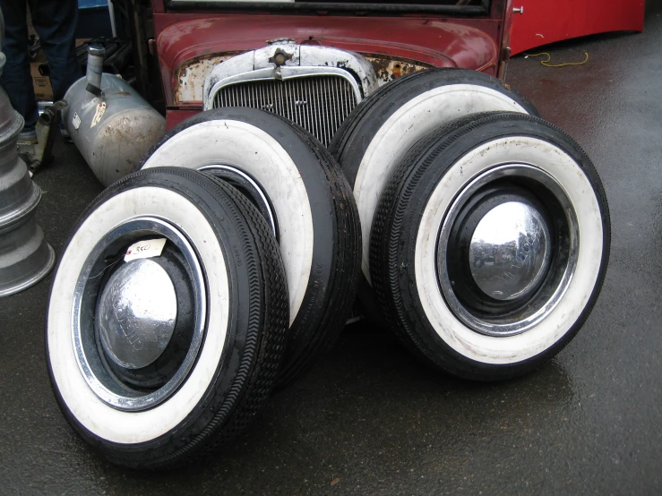 a close up of three black and white tires near the front of a truck